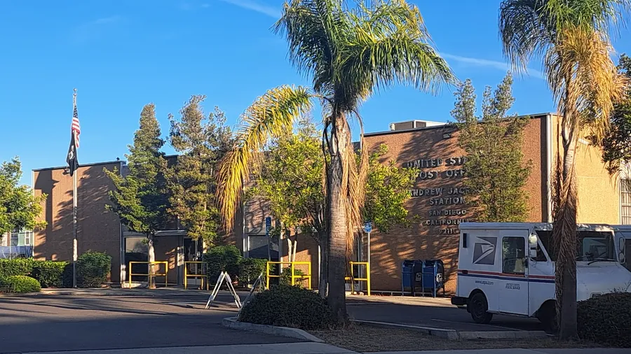 A United States Postal Service delivery station, with mail trucks parked outside