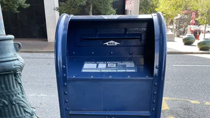 A USPS blue collection box